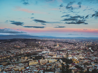Fototapeta na wymiar aerial view of city in Georgia and sky at sunset