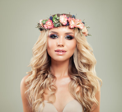 Summer Portrait of Cute Woman with Flowers and Healthy Hair. Skincare and Haircare Concept