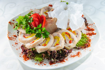 Slised meat meal with vegetables on white plate.