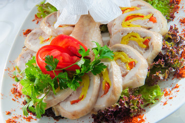 Slised meat meal with vegetables on white plate.