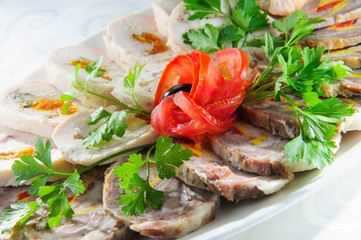 Slised meat meal with vegetables on white plate.