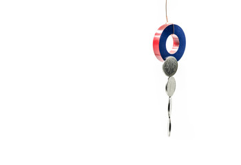 a round magnet tied to a rope collecting money over white
