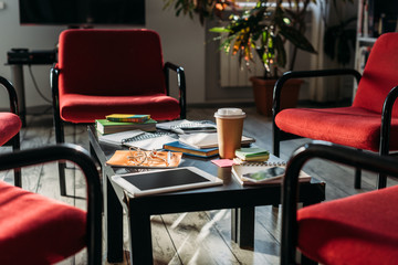 digital devices, notebooks and coffee on table at home