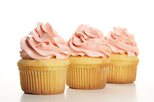 Delicious capkake with cream on a white background isolated