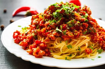 Traditional pasta spaghetti bolognese on dark wooden background