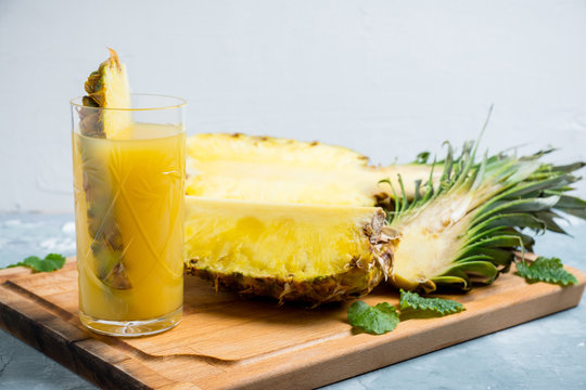Glass of pineapple juice on the rustic background. Selective focus.