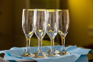 Empty glasses for champagne on the tray. The beginning of the holiday