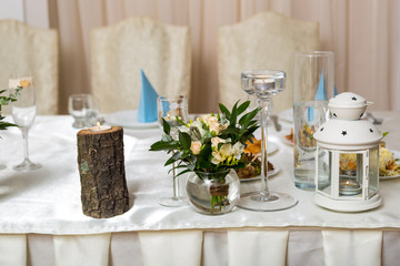 Beautiful wedding table for newlyweds is illuminated by candles