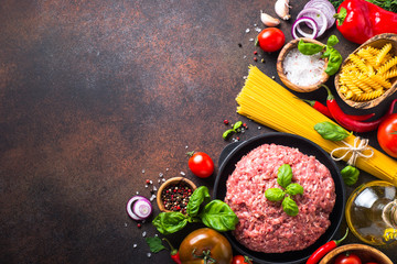 Minced meat, pasta and vegetables. Food background. Ingredients for cooking. Top view copy space.