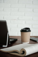 hot coffee cup on wooden table,blank coffee cup paper for insert text and graphics object,take away coffee cup mock up.