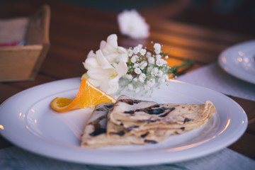  pancake with flower decoration and orange 