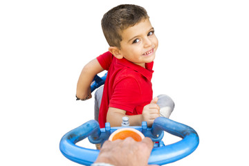 Hand pushing a child's tricycle isolated in white