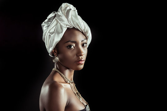 Attractive African American Woman In White Wire Head Wrap Isolated On Black