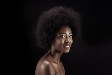 beautiful african american woman looking at camera isolated on black