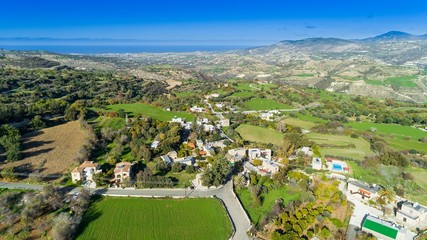 Fototapeta na wymiar Aerial bird's eye view of traditional village Kato Akourdalia, Paphos, Cyprus. The mountains, valley, trees, nature, Latchi - Akamas beach and agritourism resorts and villas in Pafos from above. 