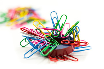 Magnet covered by paper clips isolated on a white background