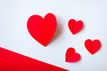Valentine day background with red hearts, top view. White background with copy space.