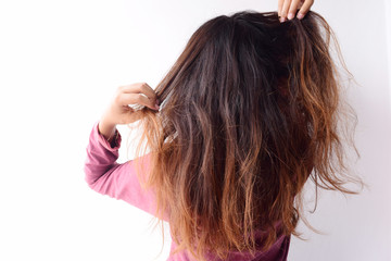 Obraz premium The back view of a woman showing her messy hair with visible split ends and damage.Emotional young girl showing her bad expression, motion portrait