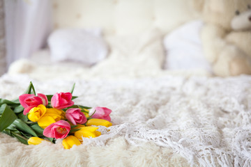 Fototapeta na wymiar Fresh tulip bouquet on bed