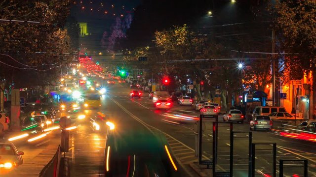 Time lapse video of cars with a long exposure at night in Yerevan on street Mashtots. The camera is approaching