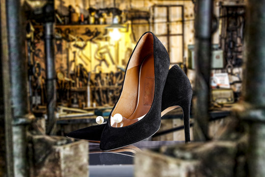 Handmade woman shoes and blurred background of workspace 