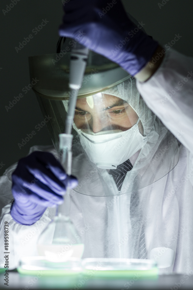 Poster life scientist researching in bio hazard laboratory. focused life science professional working on ex