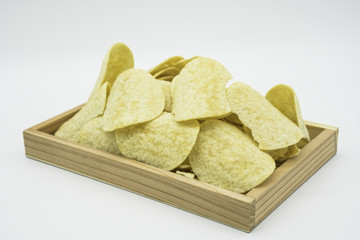 Fried yellow potato chips In wooden tray isolated on white background of file with Clipping Path .