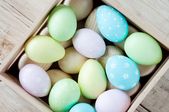 Easter eggs in a basket on rustic wooden background, selective focus image, Happy Easter!