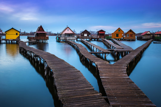 Bokod lake, Hungary - The famous floating village with piers and traditional fishing wooden cottages on a cloudy winter morning