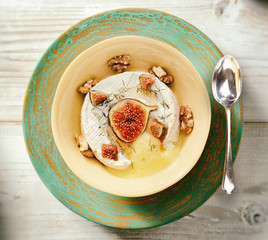 Camembert cheese oven baked with figs and walnuts.