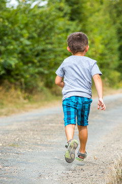 child running along a country road