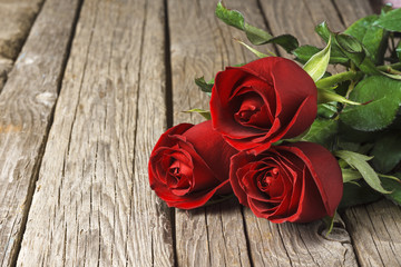 Red roses on old wooden table, Valentine's Day background