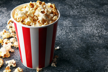 Cinema concept with popcorn in red white bag