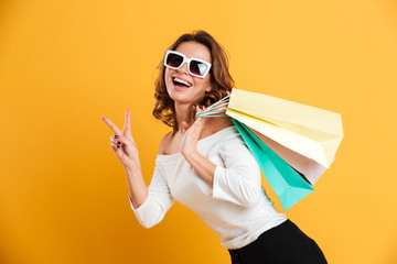 Happy young woman holding shopping bags