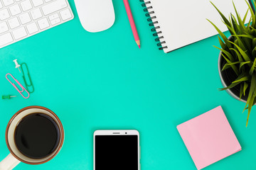 office desk with smartphone, computer and office supplies top view