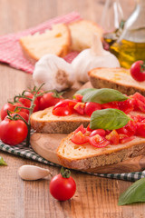 Bruschetta bread with basil and chopped tomatoes. 