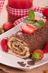 Chocolate roll with hazelnuts and strawberries. 