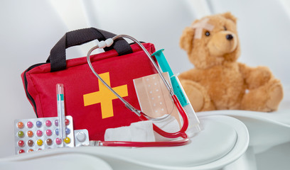 Close-up of a first aid kit next to a stethoscope
