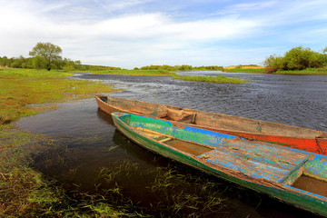 Panoramic view of wetlands and meadows with a vintage boat by the Biebrza river in Poland
