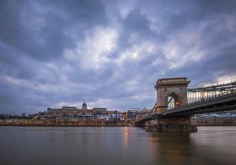 Fototapeta premium Budapest, Hungary - The famous Szechenyi Chain Bridge over River Danube with Buda Castle Royal Palace at dusk