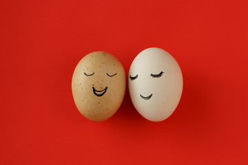 Two eggs with a joyous expression on the red background