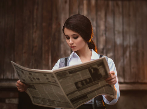 Retro Hooligan Reads The Newspaper. Vintage Businesswoman. A Woman Is Dressed Like A Man, A Vintage Style. Times Of The Great Depression