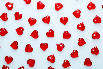 Background for St. Valentine's Day.
Decorative red hearts on a white background