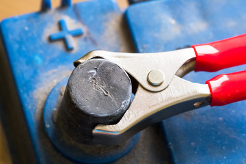 Terminals of the old dirty battery. Charging car battery with electric current.