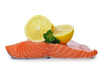 Fresh raw salmon fillet with lemons isolated on a white background.