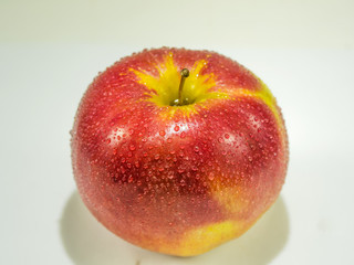 Beautiful ripe red apple closeup on white