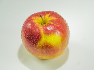 Beautiful ripe red apple closeup on white