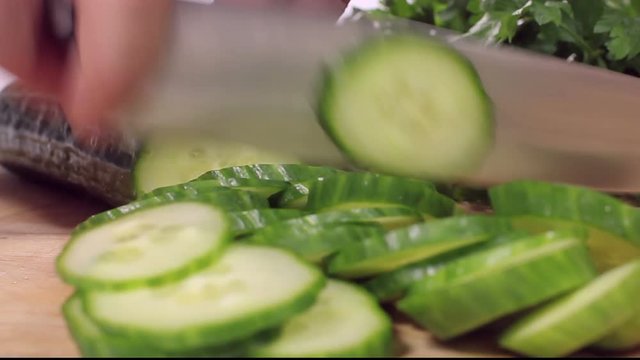 Slicing cucumber  on wooden bord 