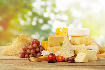 Variety of cheese types composition on wooden board
