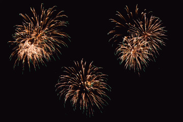 Obraz premium Colorful firework on the night sky. New Year celebration fireworks. Abstract firework isolated on black background with free space for text